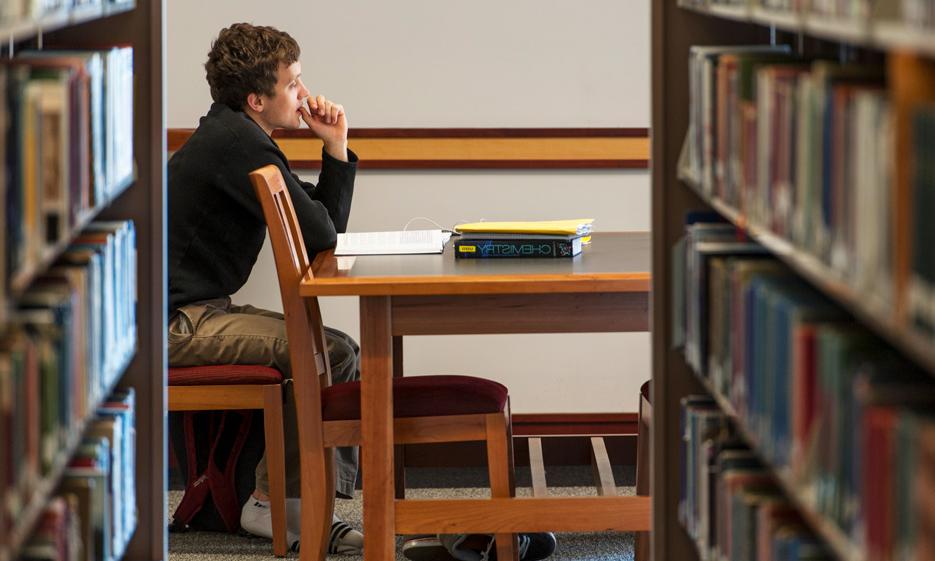 Male student studying in the library